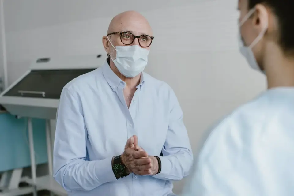 A veterinary behaviorist speaking with a dog owner during a consultation